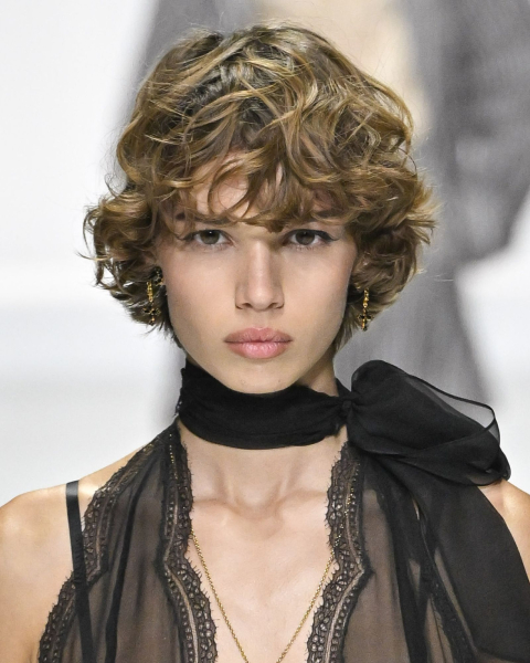 Closeup shot of a runway model with an '80s shaggy bob